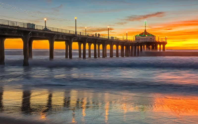 A long pier overlooking the sea at sunset