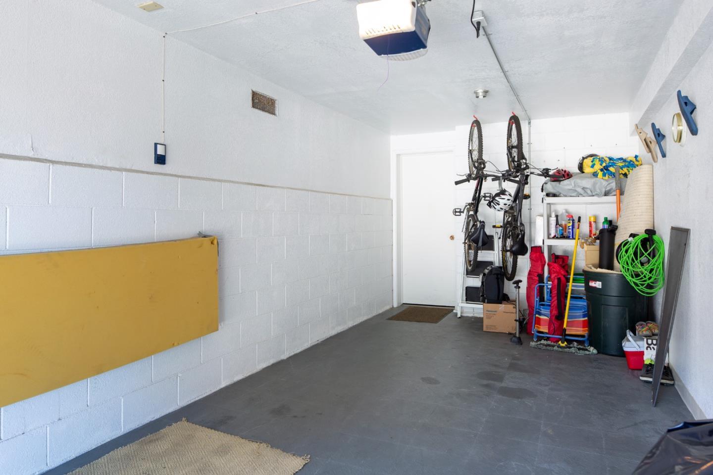 Garage with bicycles and sports gear stored along the right wall.