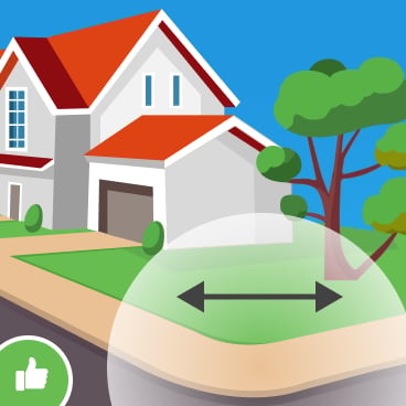Illustrated corner lot with a house, trees, and a double-headed arrow across the lawn.