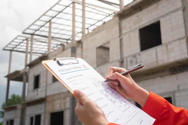 architect project engineer is checking house building quality checklist inspecting