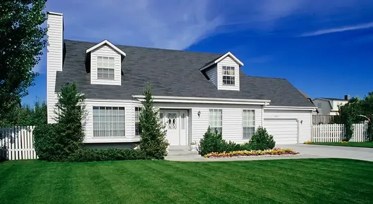 A single-story house with a well-maintained lawn and driveway.