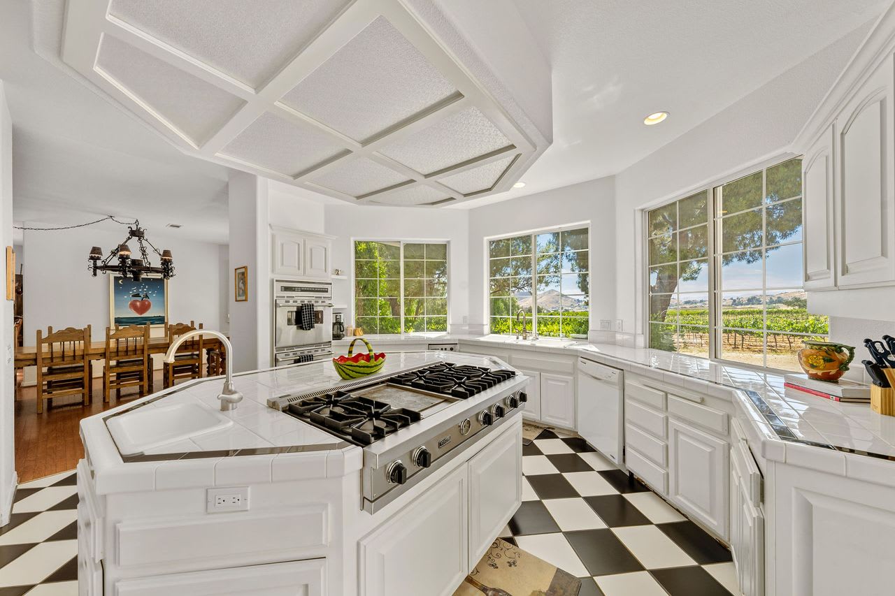 Kitchen with panoramic vineyard views at this Los Angeles winery estate for sale.