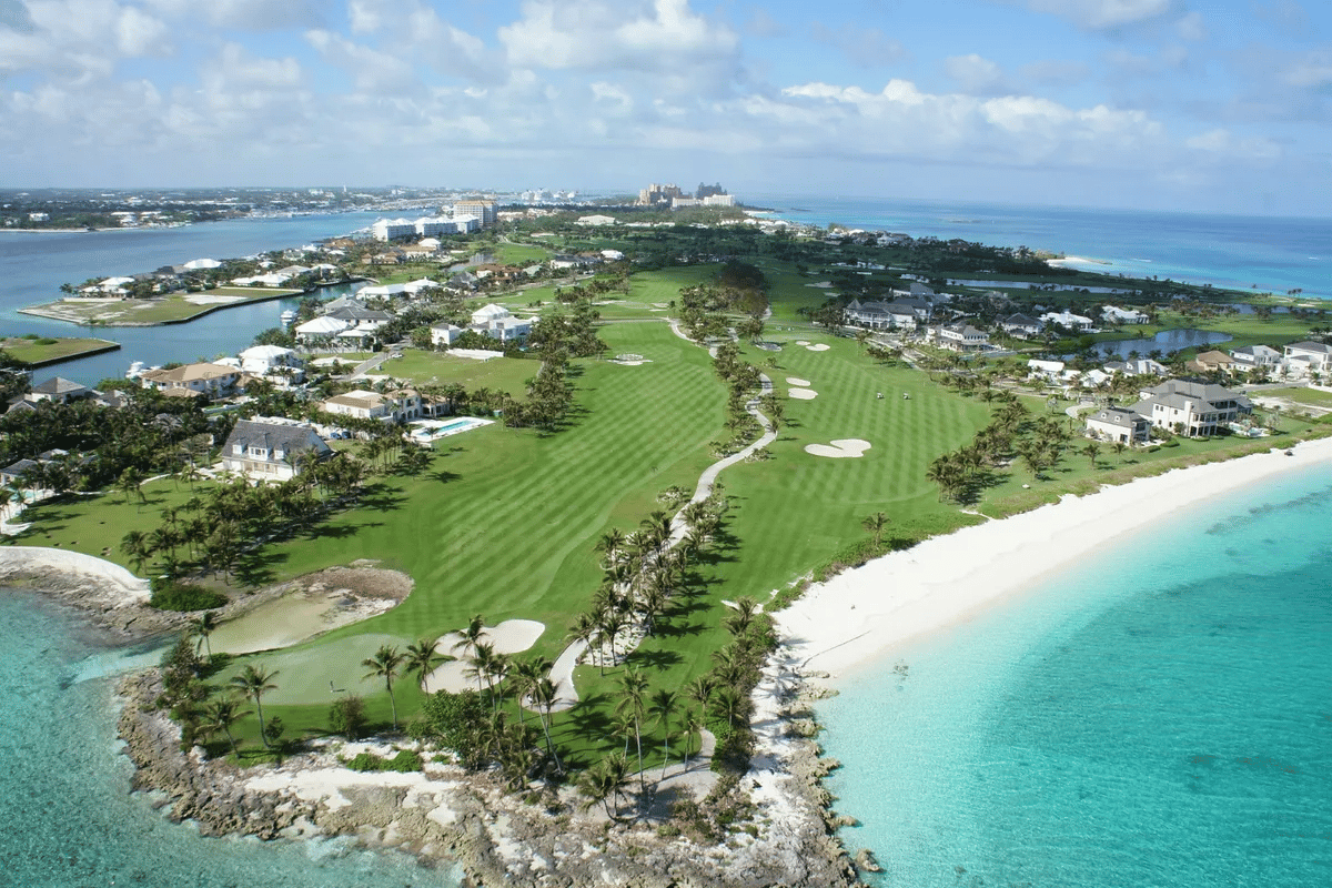 An aerial view of a golf course on a tropical island.