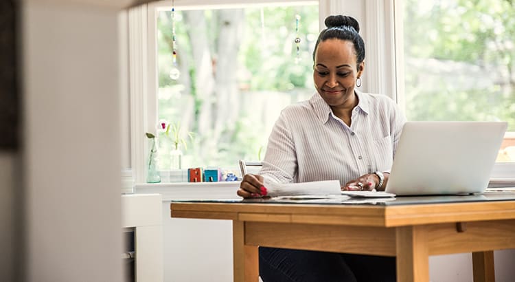 A woman working at a desk, suggesting themes of remote work, home office, or professional development.