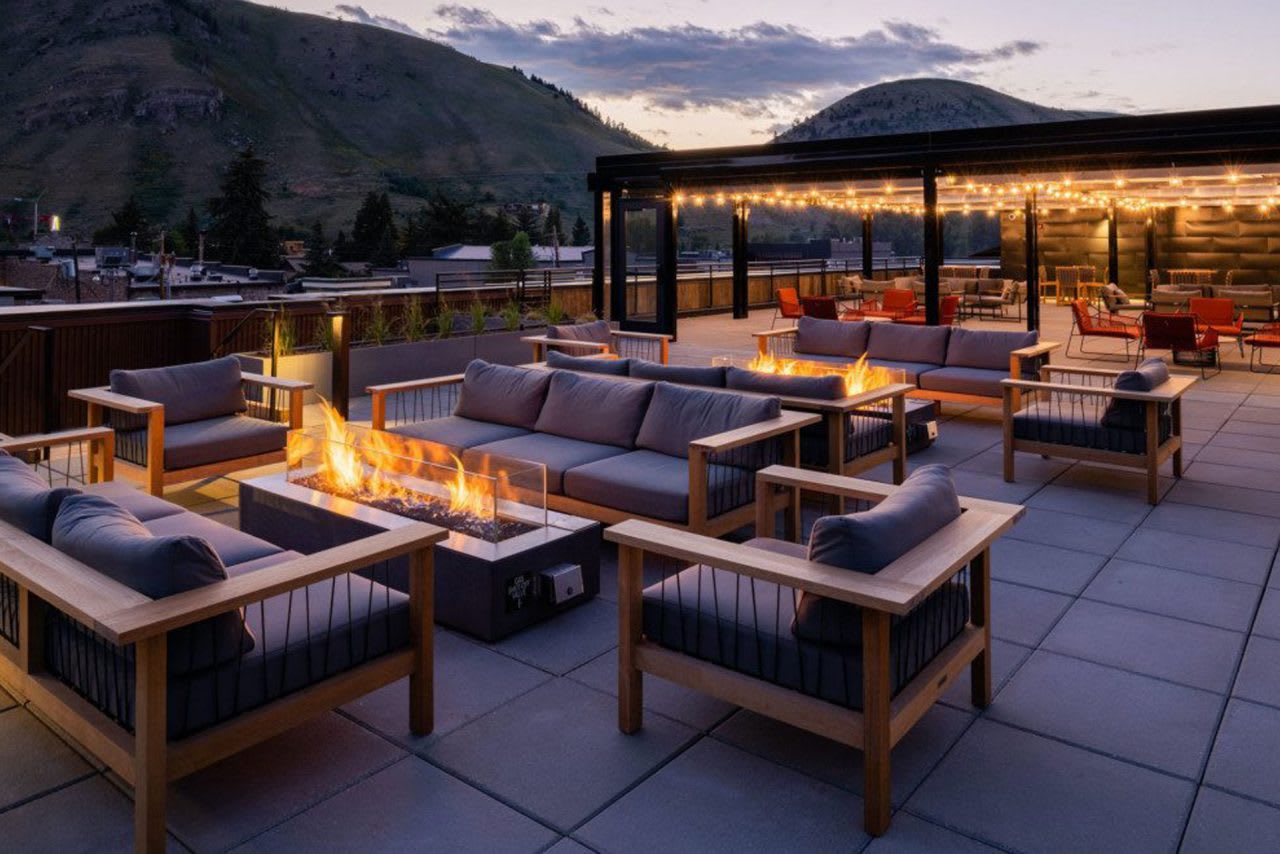 Jackson Hole real estate agent Cole Mizak highlights top dining spots in Jackson, WY, showcasing the local lifestyle with a backdrop of homes for sale and stunning mountain views.