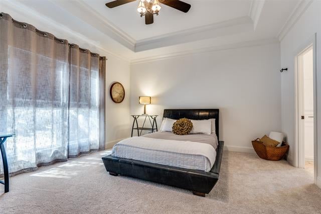 Bedroom with a black bed, white bedding, and tall windows covered by sheer curtains.