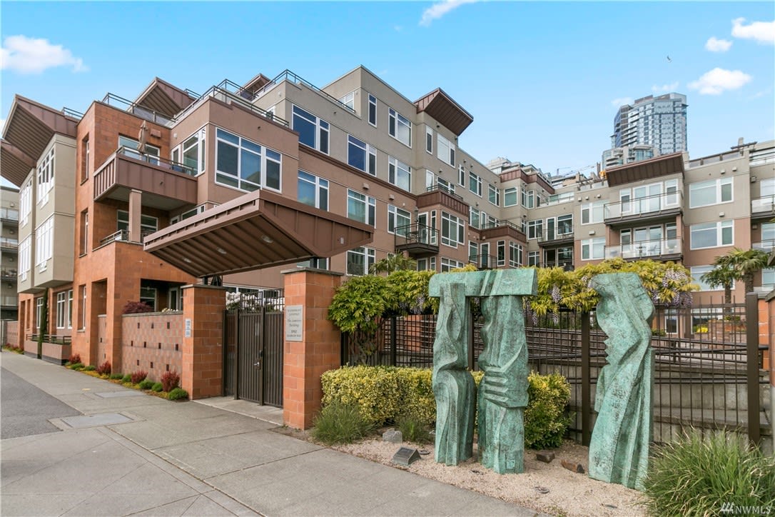 Elegant sculptures frame the entrance to this modern condo building. 