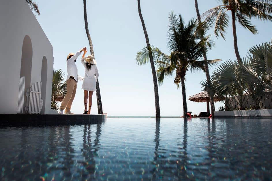 a couple dancing beside the pool