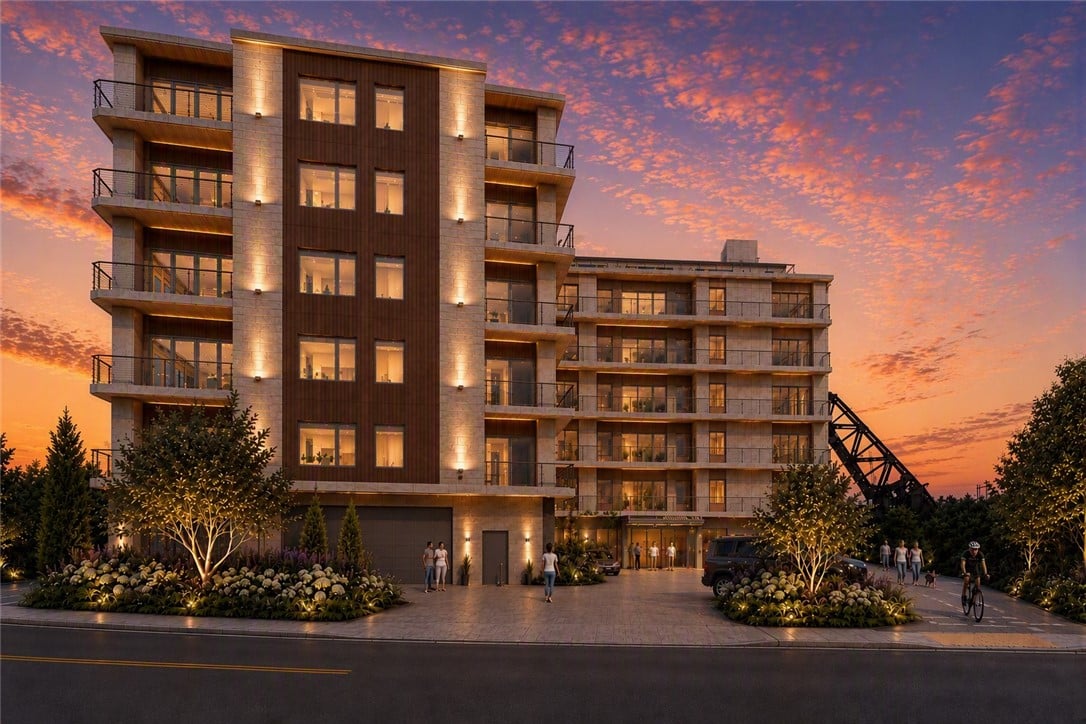 Five Richmond residences at dusk, with glass balconies, a landscaped entrance, and an illuminated facade.
