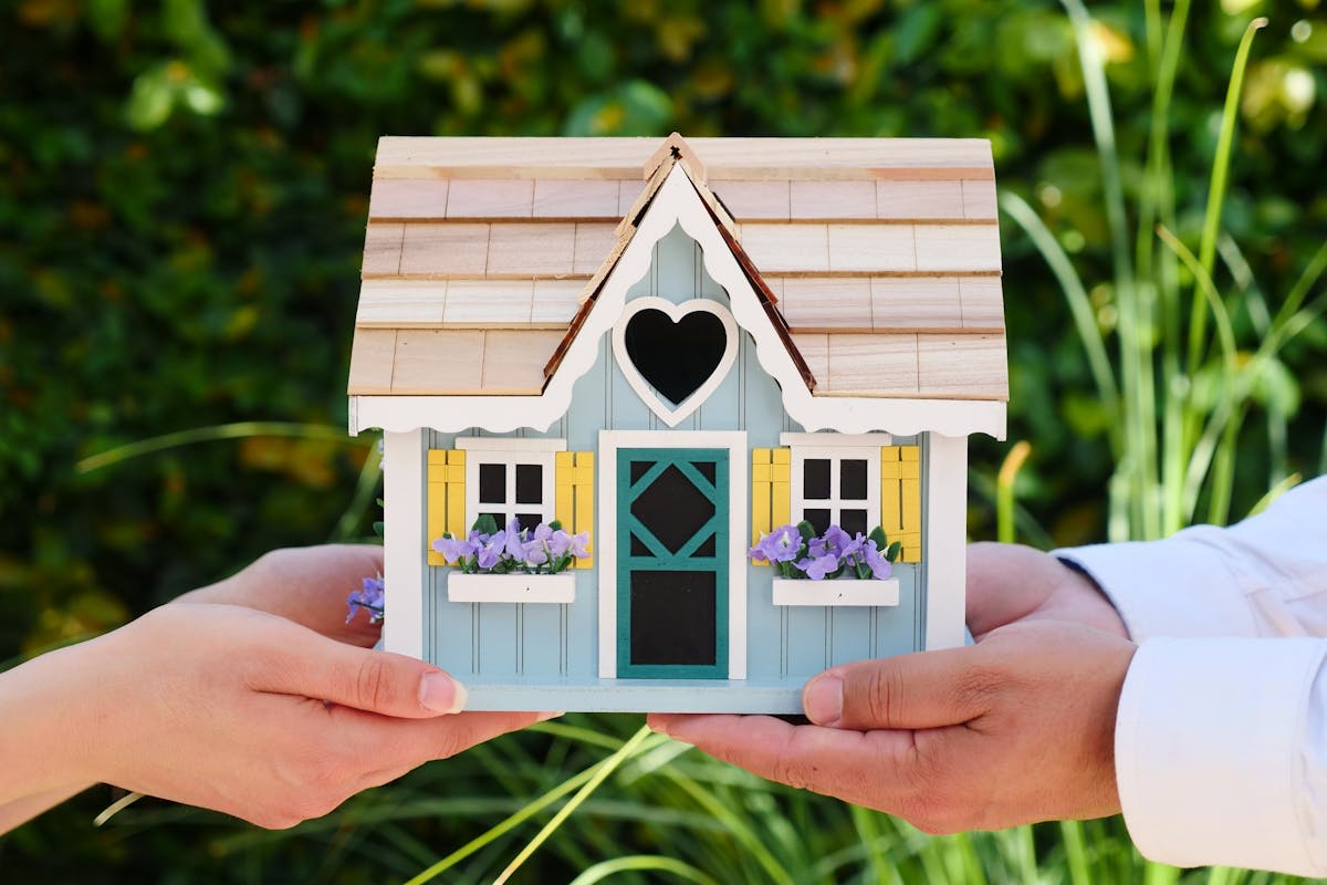 a-couple-holding-a-miniature-house-illustrating-portability-in-real-estate