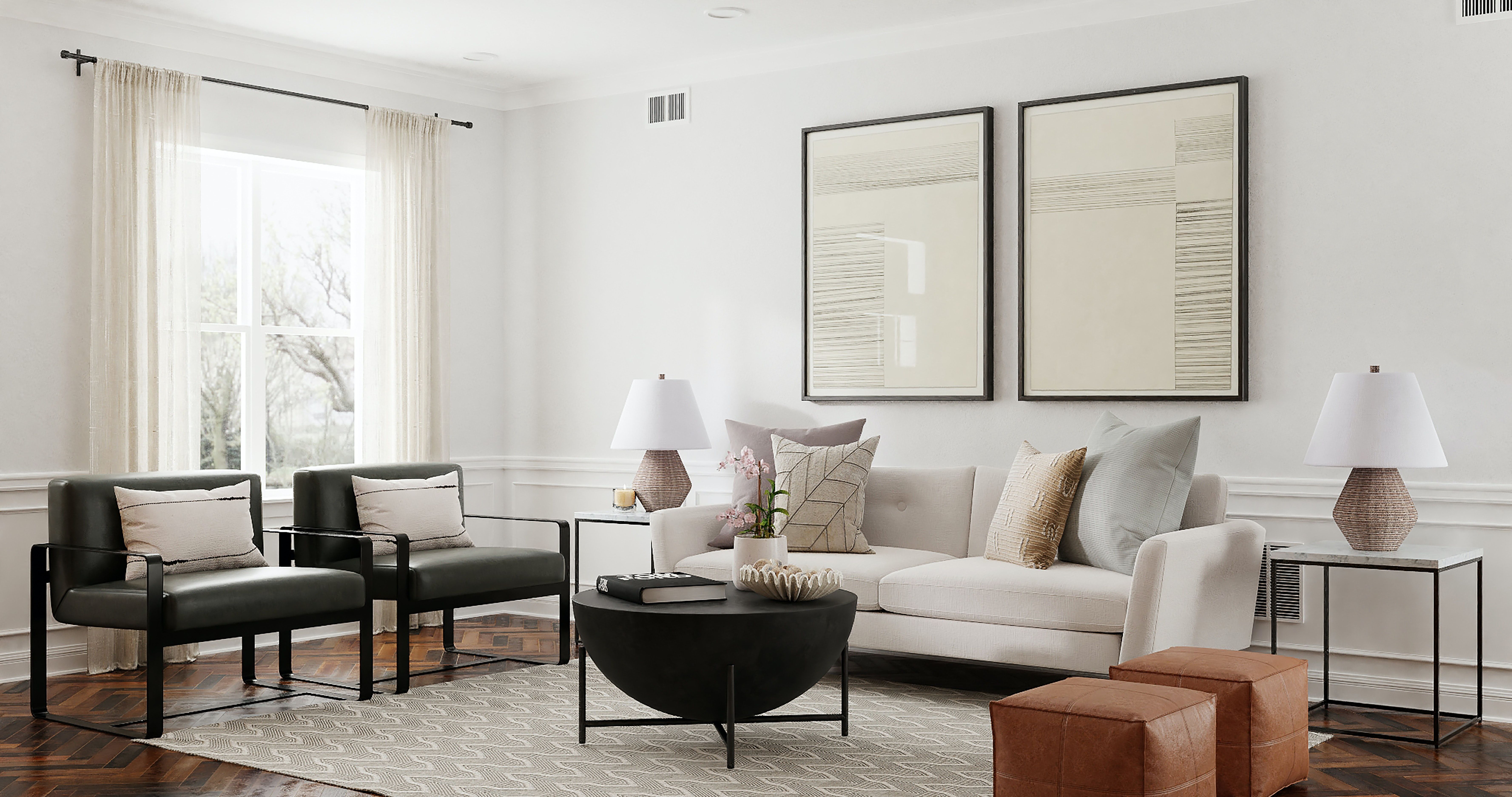 Staged living room with a white sofa, dark armchairs, and a round black coffee table.