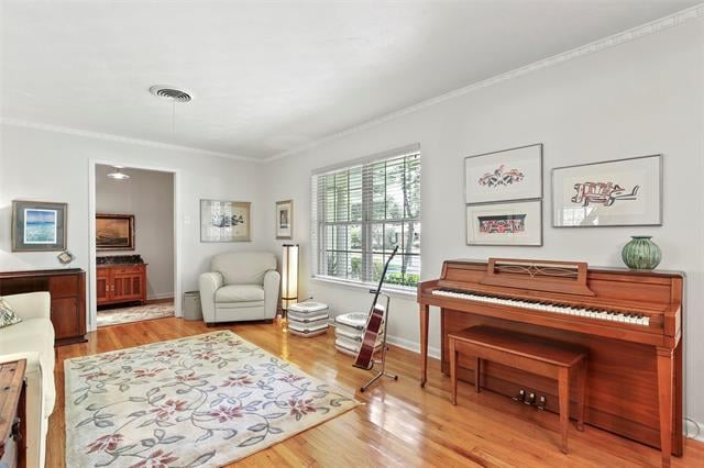 Music room with a polished upright piano, guitar, armchair, and large window.