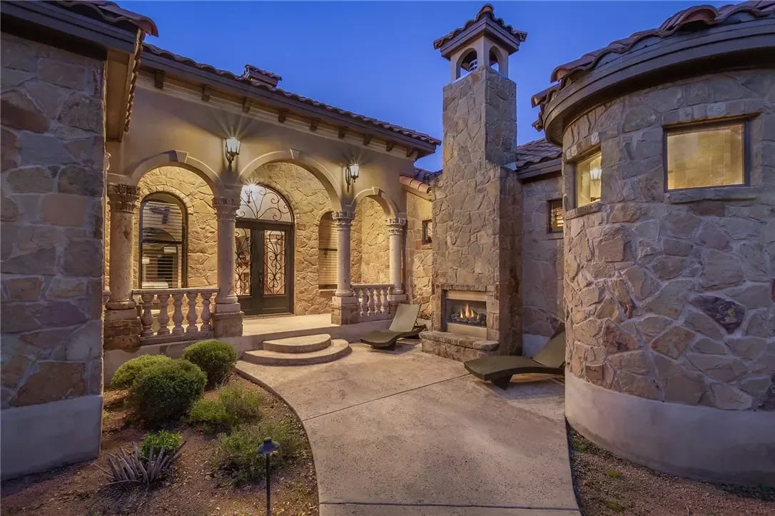 A luxurious stone house with a fireplace in the courtyard.