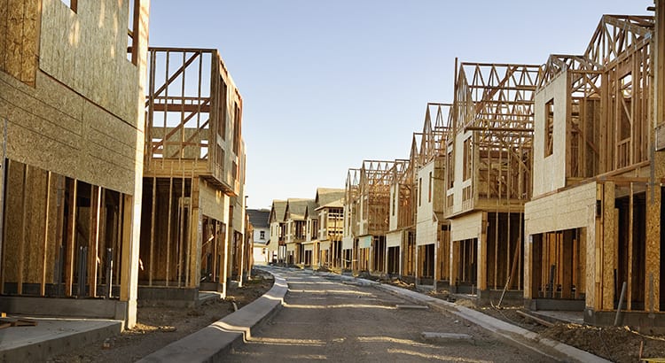 A construction site with partially built houses, likely represents new home construction or real estate development.