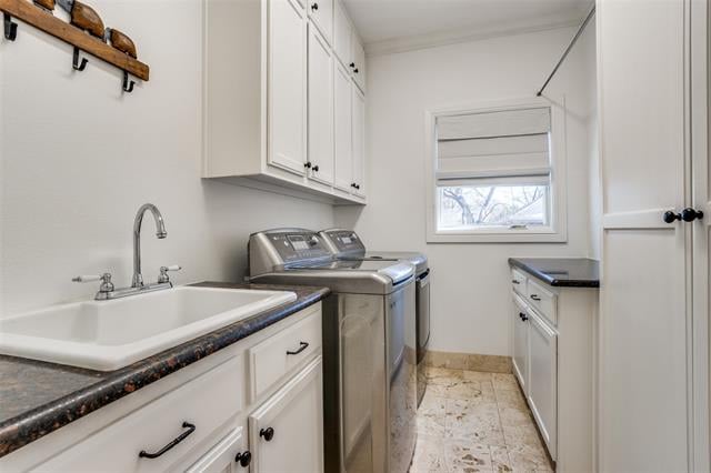 Laundry room with white cabinets, utility sink, washer and dryer, and a window with a Roman shade.