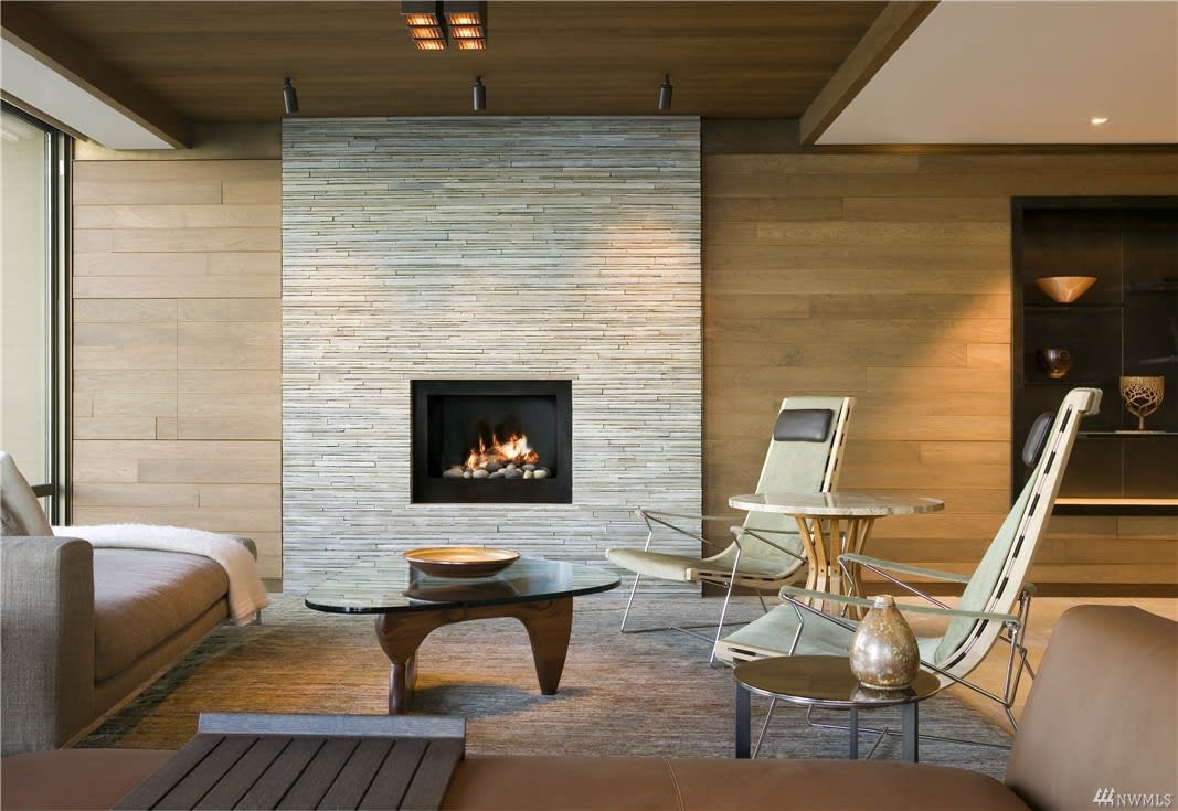 Chic condo living room with a minimalist fireplace, creating a cozy yet modern retreat.