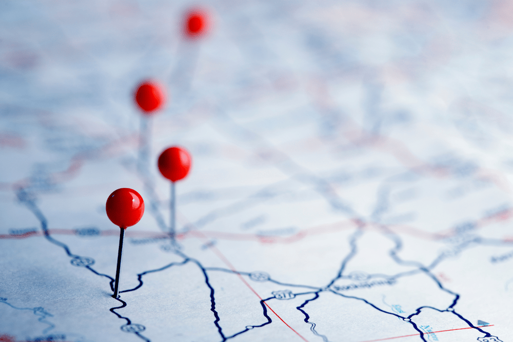 Road map marked with several red location pins.