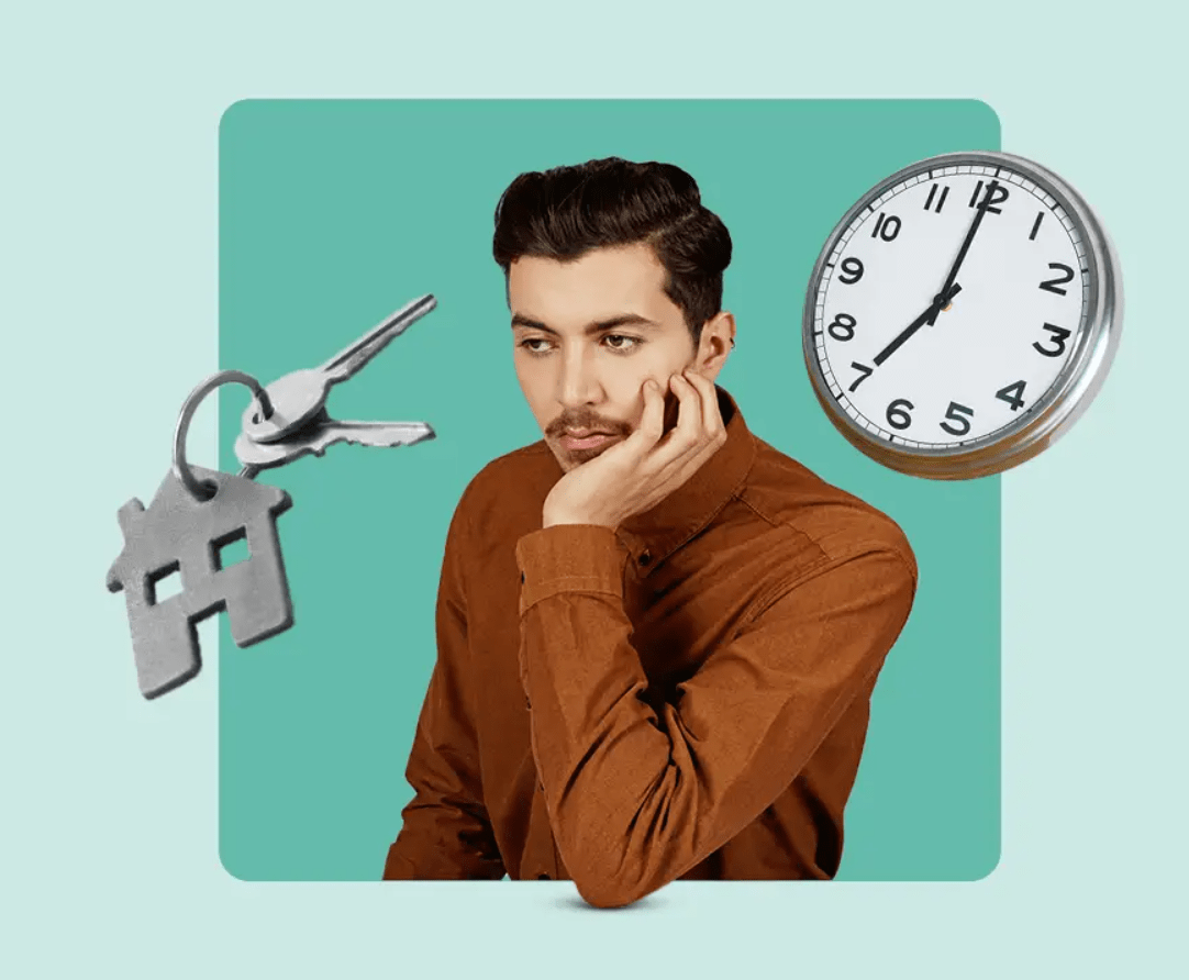 A thoughtful man between house keys and a clock, representing when to buy a home.