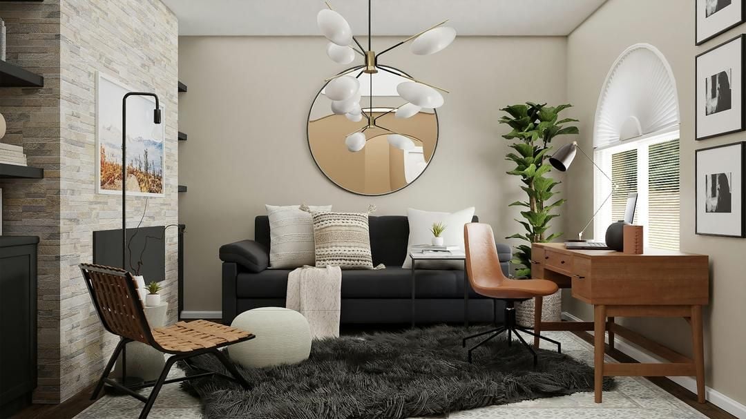 Living room with a black sofa, stone fireplace wall, round mirror, and wood desk beside a window.