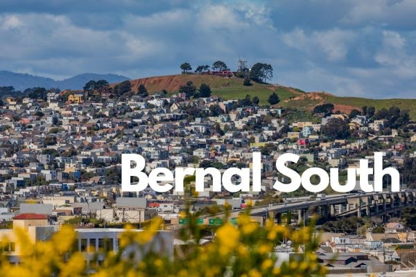 Bernal Heights southern slope with yellow flowers in the foreground