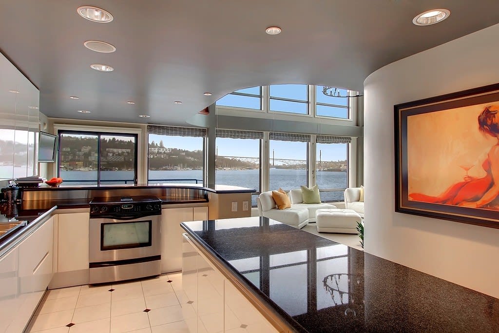 Sleek kitchen in a luxury waterfront condo with panoramic views, blending modern design with comfortable living.