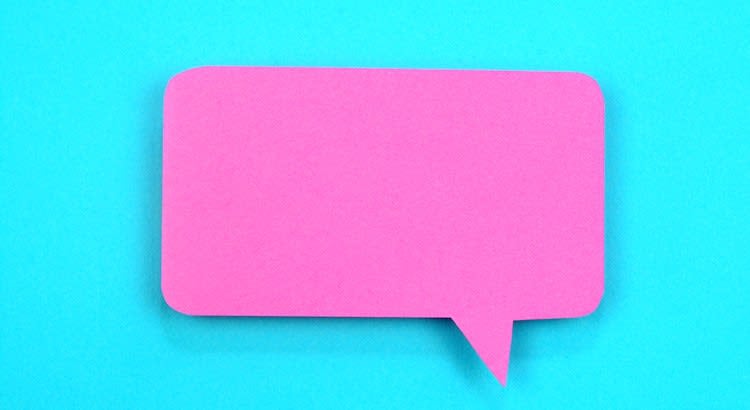 A bright pink speech bubble on a blue background, possibly used for a social media or communication-related theme.