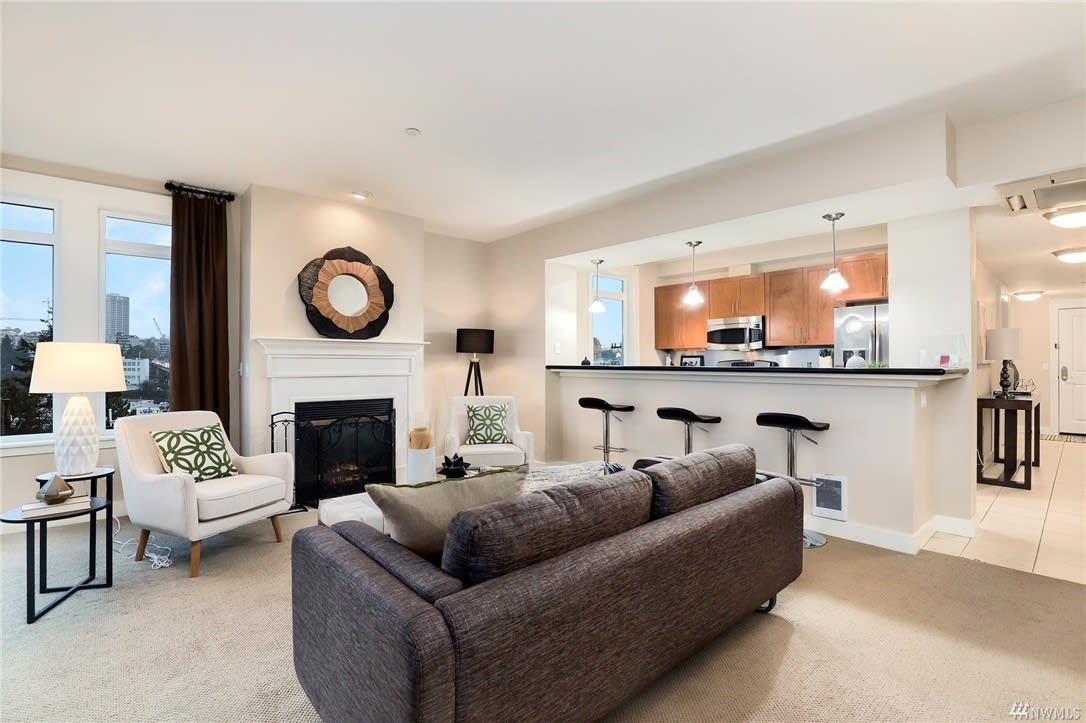 Stylishly decorated living room with plush seating, fireplace, and inviting atmosphere in a luxury estate.