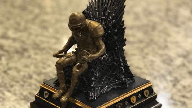 Statue of a football player sitting on a throne