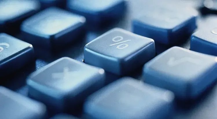 A close-up of computer keys with house-related icons, suggesting online real estate or digital property searches.