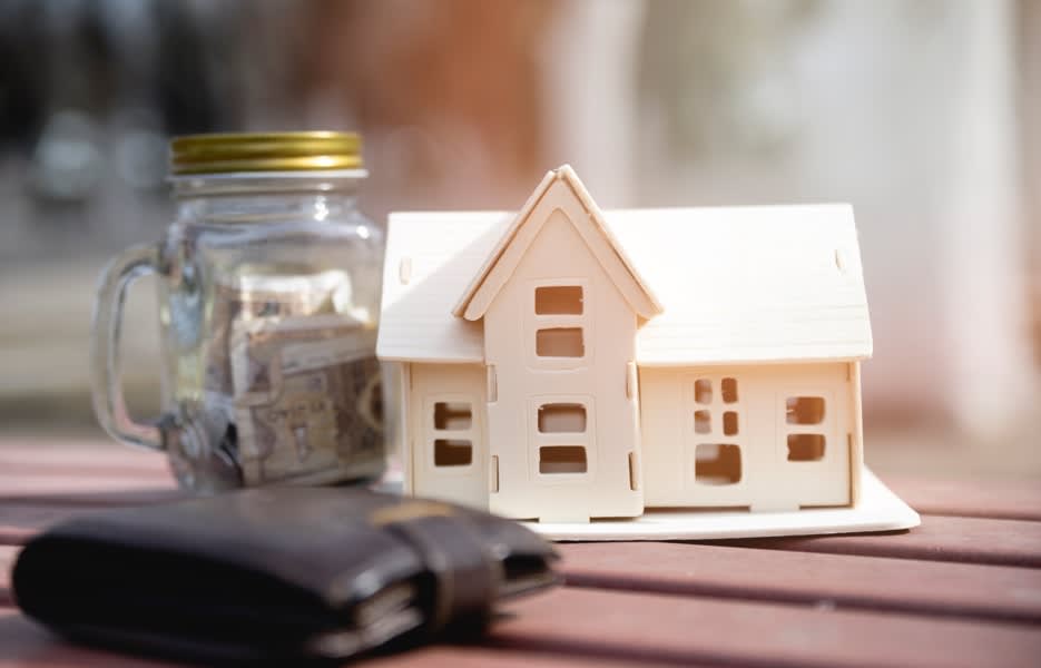 house model glass jar with money and wallet