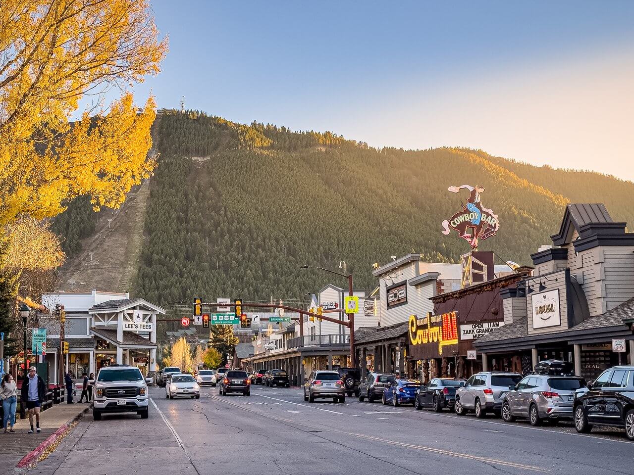 Jackson Hole real estate agent Cole Mizak reviewing luxury homes for sale with a scenic mountain backdrop in Jackson, WY, highlighting 2024 market trends and spring 2025 predictions.