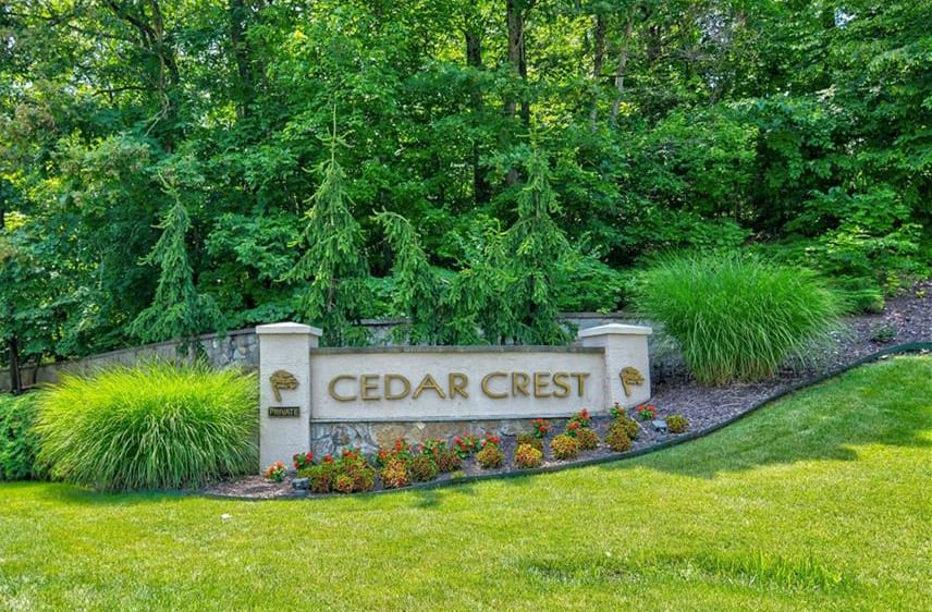 Cedar Crest sign in gold letters, mounted on a stone wall