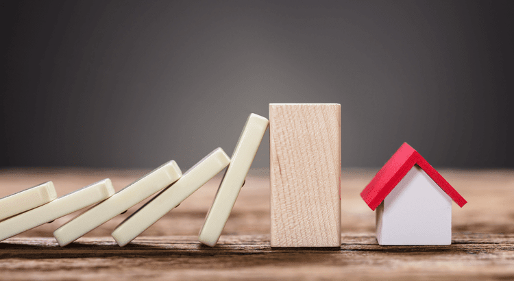 A series of dominoes cascading down towards a small house, illustrating a chain reaction in a playful scene.