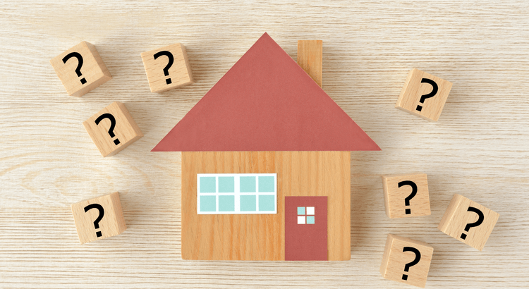 An illustration of a house with question marks around it, representing questions or considerations related to home buying or real estate.