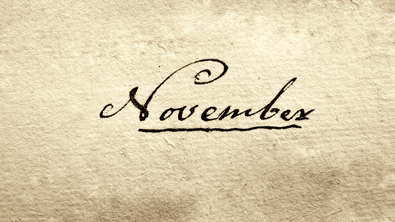 The word "November" written in a decorative, cursive script. The writing appears on a textured, parchment-like background that gives the image a vintage or antique feel.