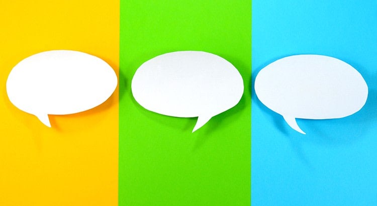 Three colorful overlapping speech bubbles on a blue, green, and yellow background, symbolizing communication or conversation.