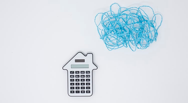 A small house calculator icon with a scribbled blue cloud above it.