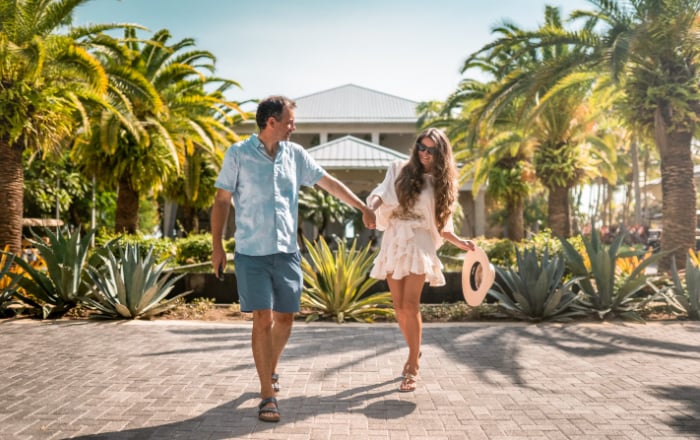 a couple walking through the courtyard at the resort