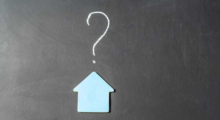 A blackboard with a question mark and an upward-pointing arrow cutout, possibly indicating a concept related to future plans or inquiries.