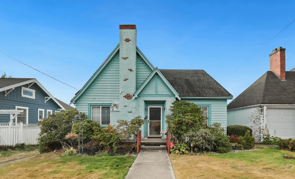 light blue home with exposed brick in chimney