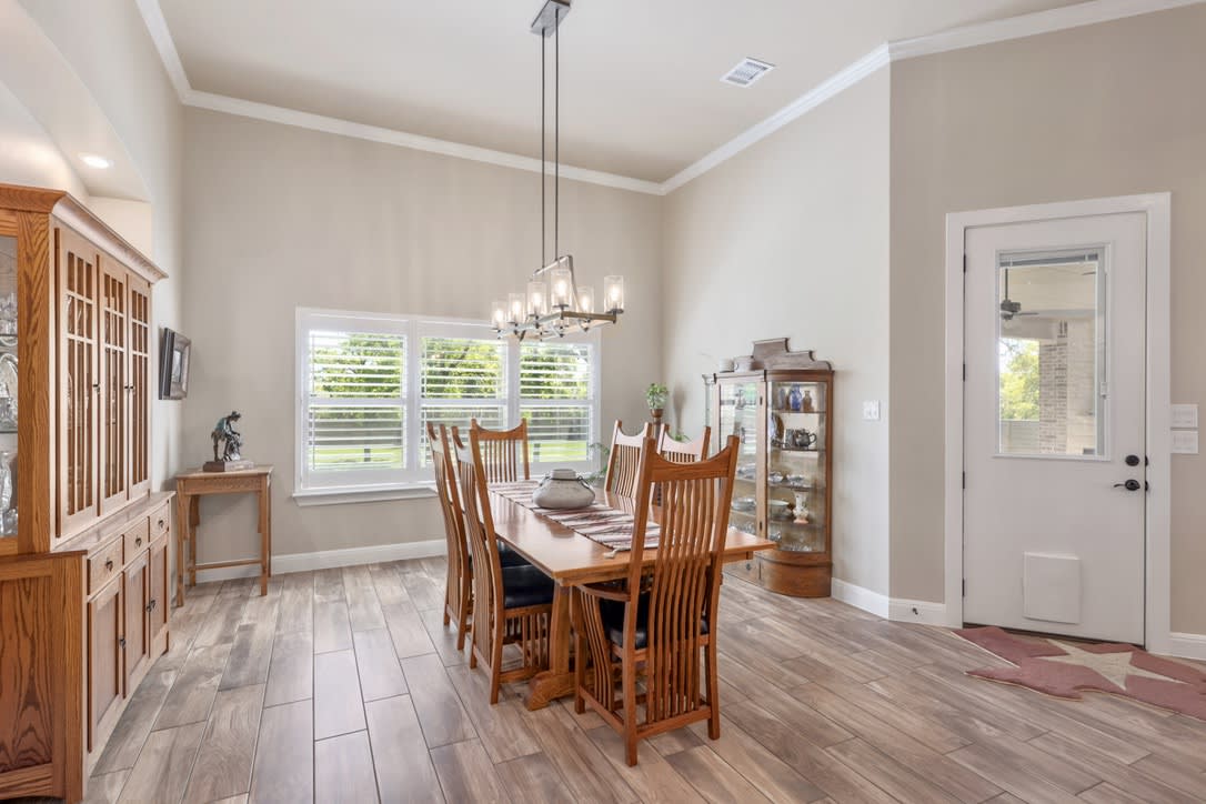 The formal dining area is complimenting the indoor-outdoor flow to the expansive outdoor patio.