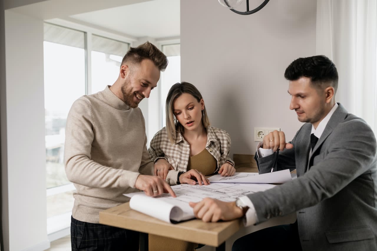 A couple talking to their realtor.