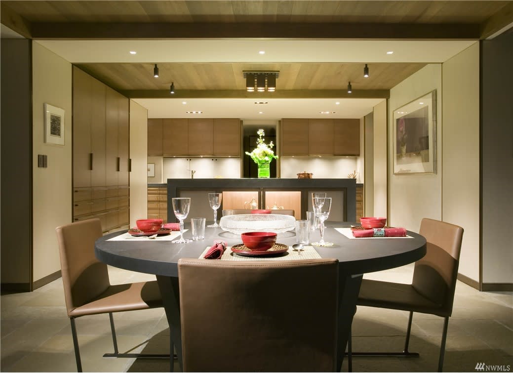 Sophisticated dining area in a luxury condo, with warm wood tones and elegant table setting.