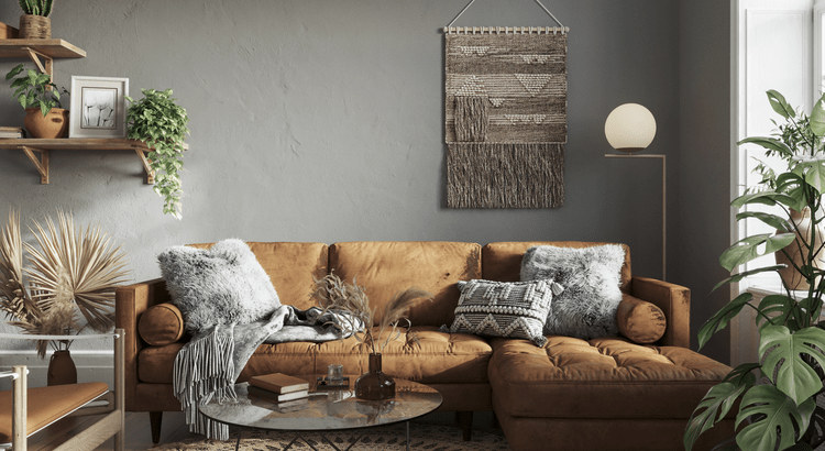  A stylish living room with a brown leather couch, decorative pillows, a coffee table, and a potted plant. The room has a contemporary design.