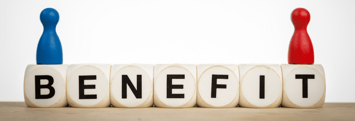 A lettered blocks spelling the word "BENEFIT", along with two game pieces placed on top. 