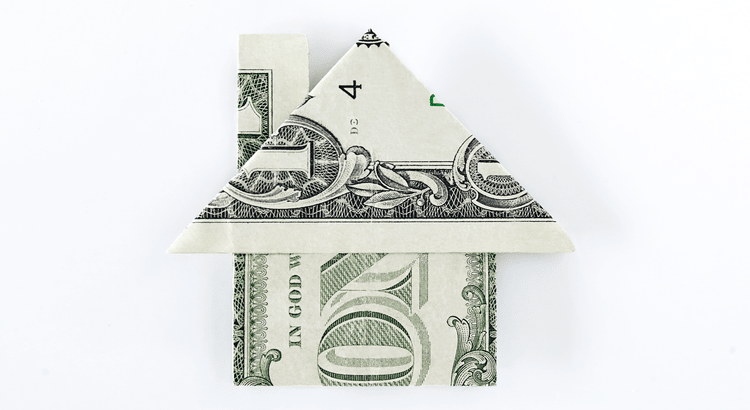 A folded dollar bill in the shape of a house, symbolizing real estate investment or home buying.