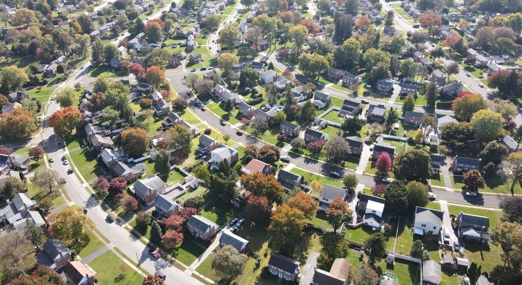 An aerial view of a suburban neighborhood, likely related to market trends or real estate investment. 