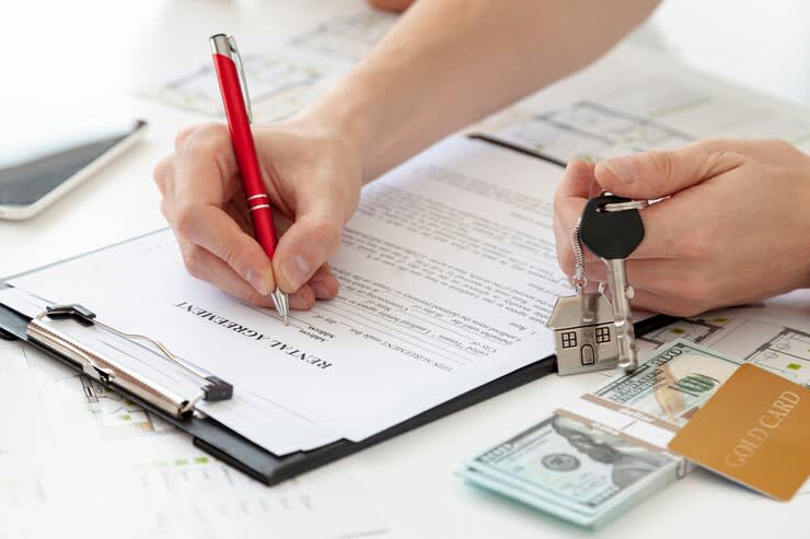 man signing for a rental agreement