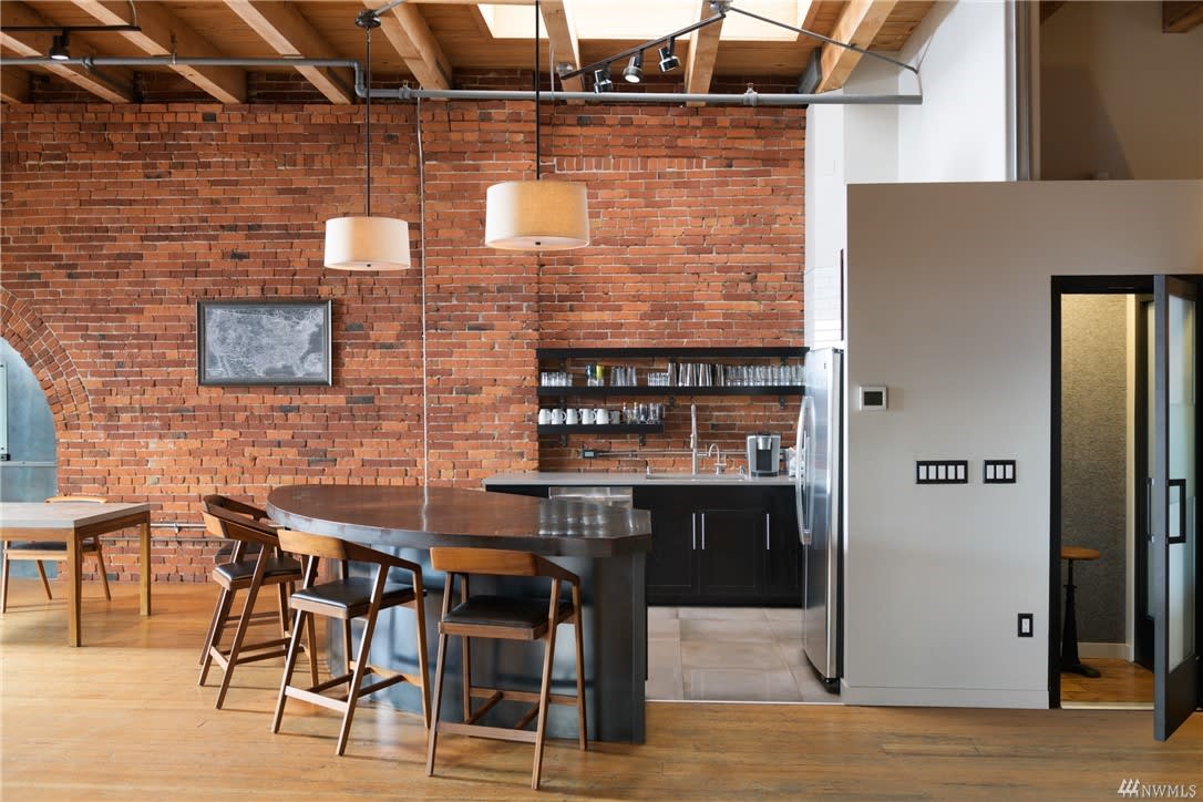 Chic loft condo blends industrial charm with modern amenities.