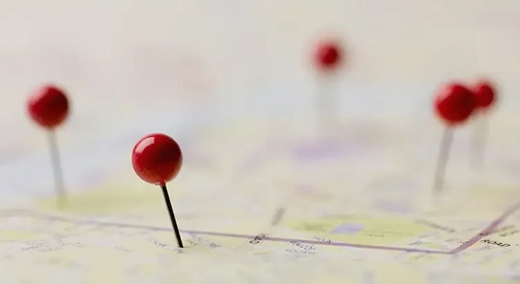 A map with several red push pins marking different locations. The image suggests navigation, planning, or real estate locations.